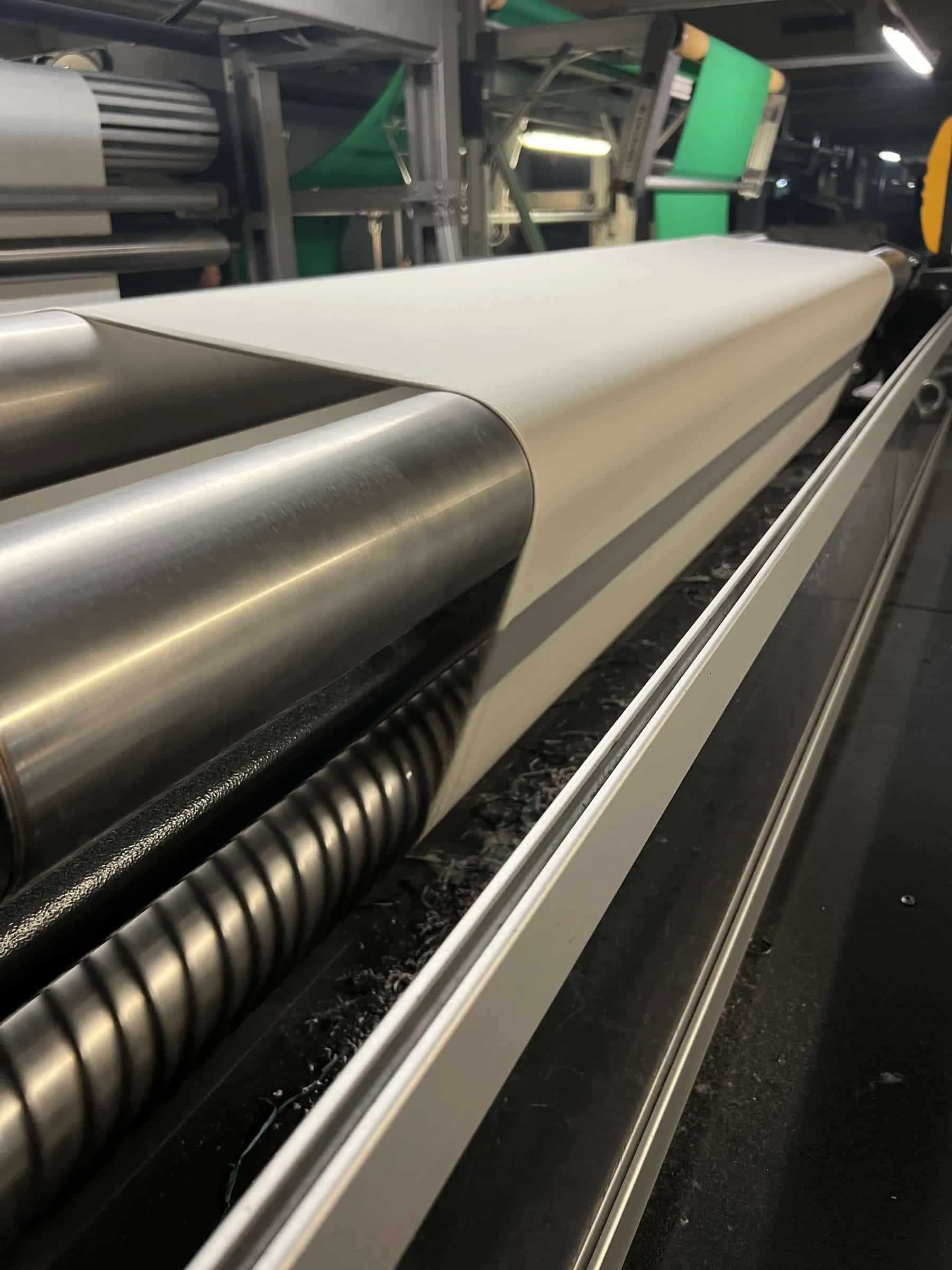 Textile material running through an industrial finishing line