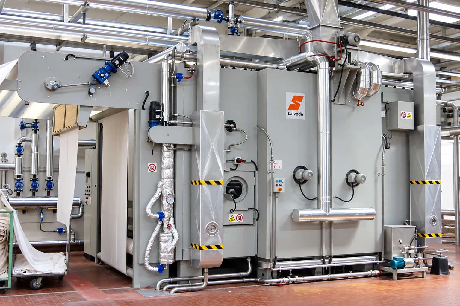 Salvadè industrial continuous steamer with fabric running through it